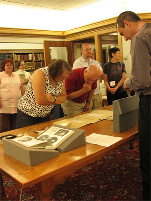 People reading the special collections in the Amherst College archives