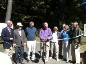 Bill Vickery cuts the ribbon as other board members look on.