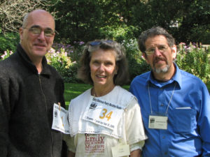 Three smiling volunteers at the Amherst poetry fest, 2009
