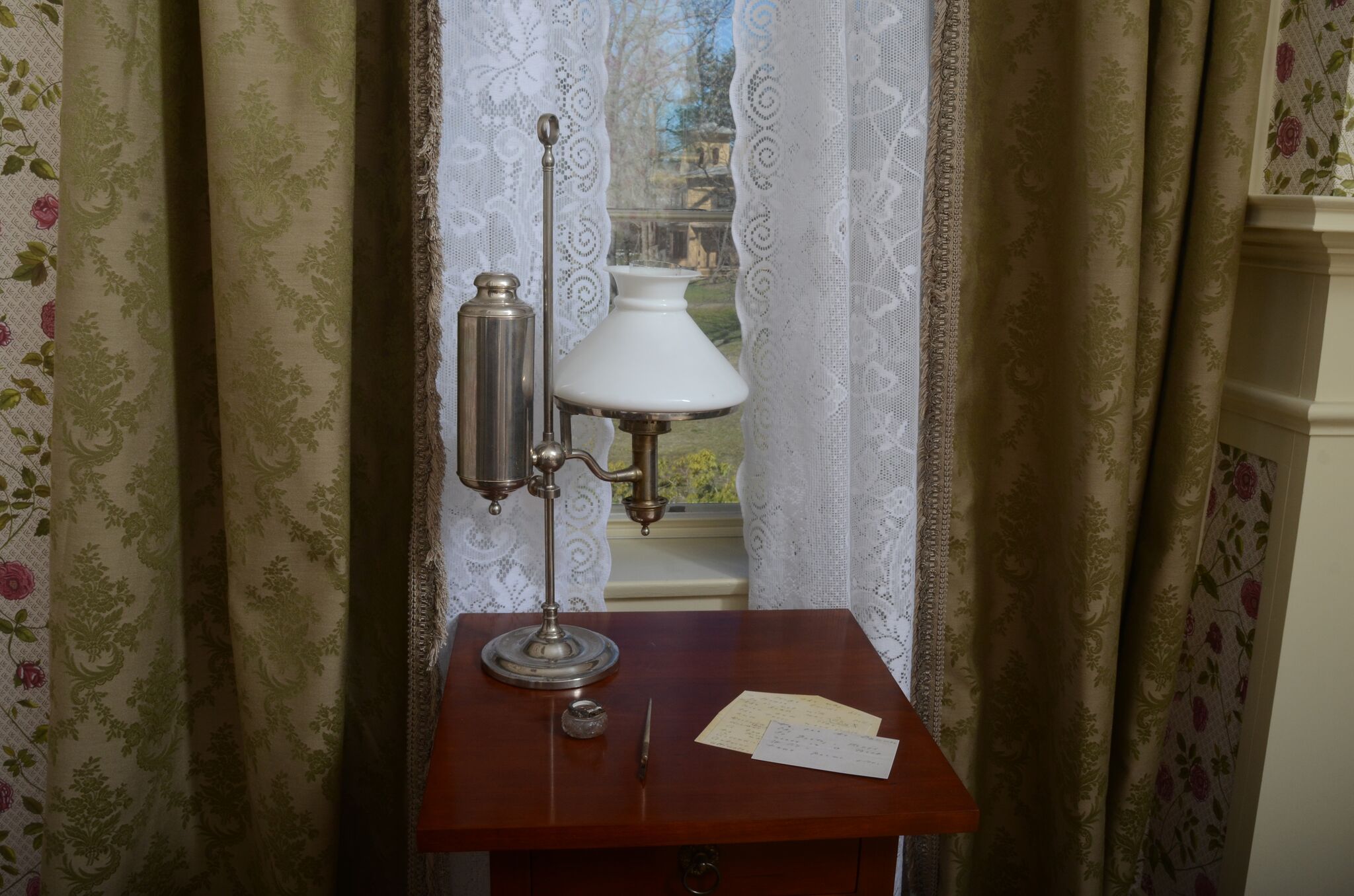 Emily's bedroom with her dress and bed and writing table
