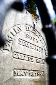 Dickinson's grave shot form below and through the fence showing the inscription "Called Back"