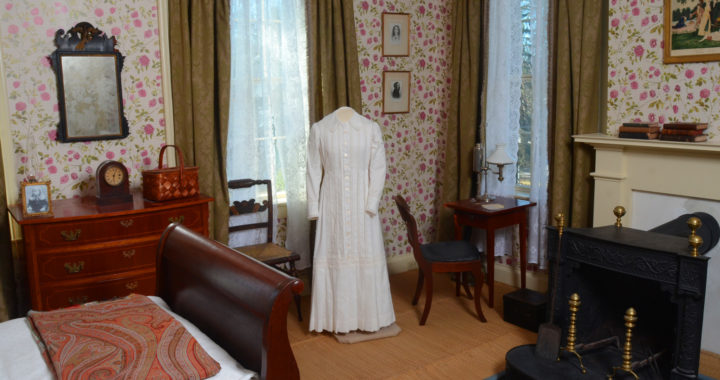 Emily's bedroom with her dress and bed and writing table