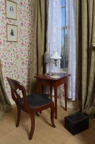 chair and small writing desk in Emily's bedroom