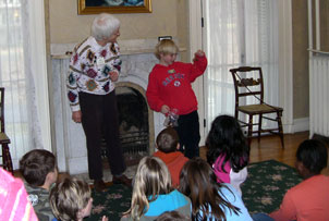 A school group presenting poems in the parlor 