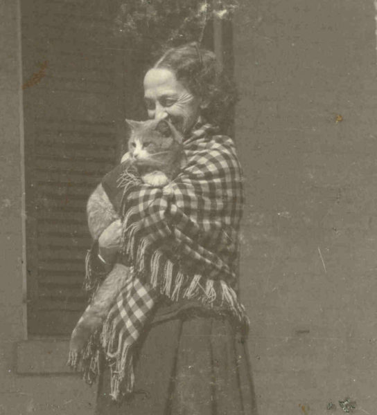 black and white photograph of Lavinia Dickinson wearing a checkered shawl and holding a cat