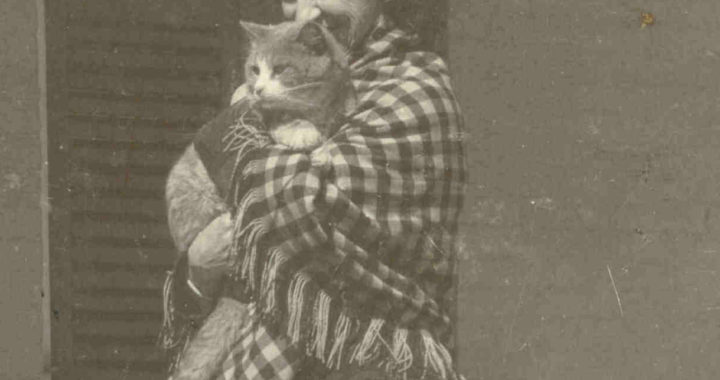 black and white photograph of Lavinia Dickinson wearing a checkered shawl and holding a cat