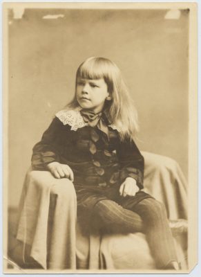 black and white photograph of a young Gib seated and wearing his "little lord Fauntleroy suit"