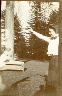 Black and white photograph of a young Martha playing with a pet dog