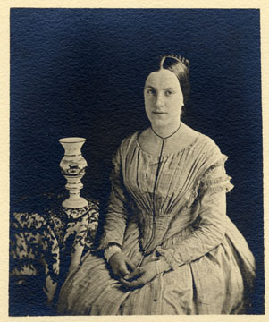 black and white photograph, of young woman seated