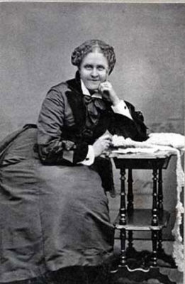 black and white photograph of Jackson seated and leaning upon a small table