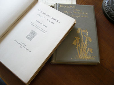 "The Single Hound, Poems of a Lifetime" (left) by Emily Dickinson, edited by Martha Dickinson Bianchi, and "Poems" (right) by Emily Dickinson edited by Mabel Loomis Todd and Thomas Wentworth Higginson