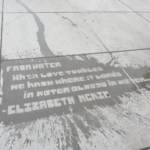 Lettering on a sidewalk washed by rain