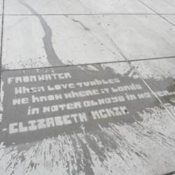 Lettering on a sidewalk washed by rain