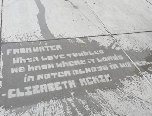 Lettering on a sidewalk washed by rain