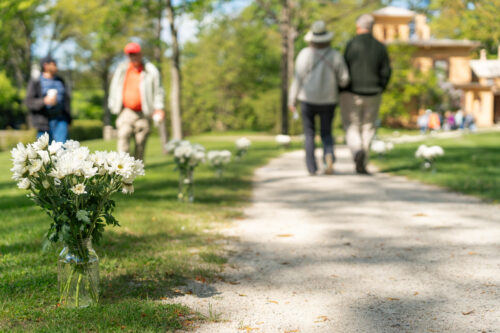 couples walk the path from the Homestead to The Evergreens during the Museum's annual poetry walk