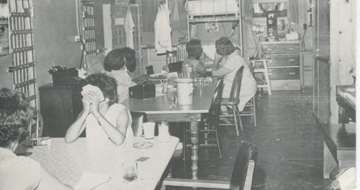 black and white photo of incarcerated women playing cards.