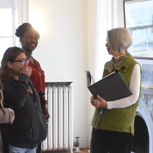 College students speaking with a museum guide