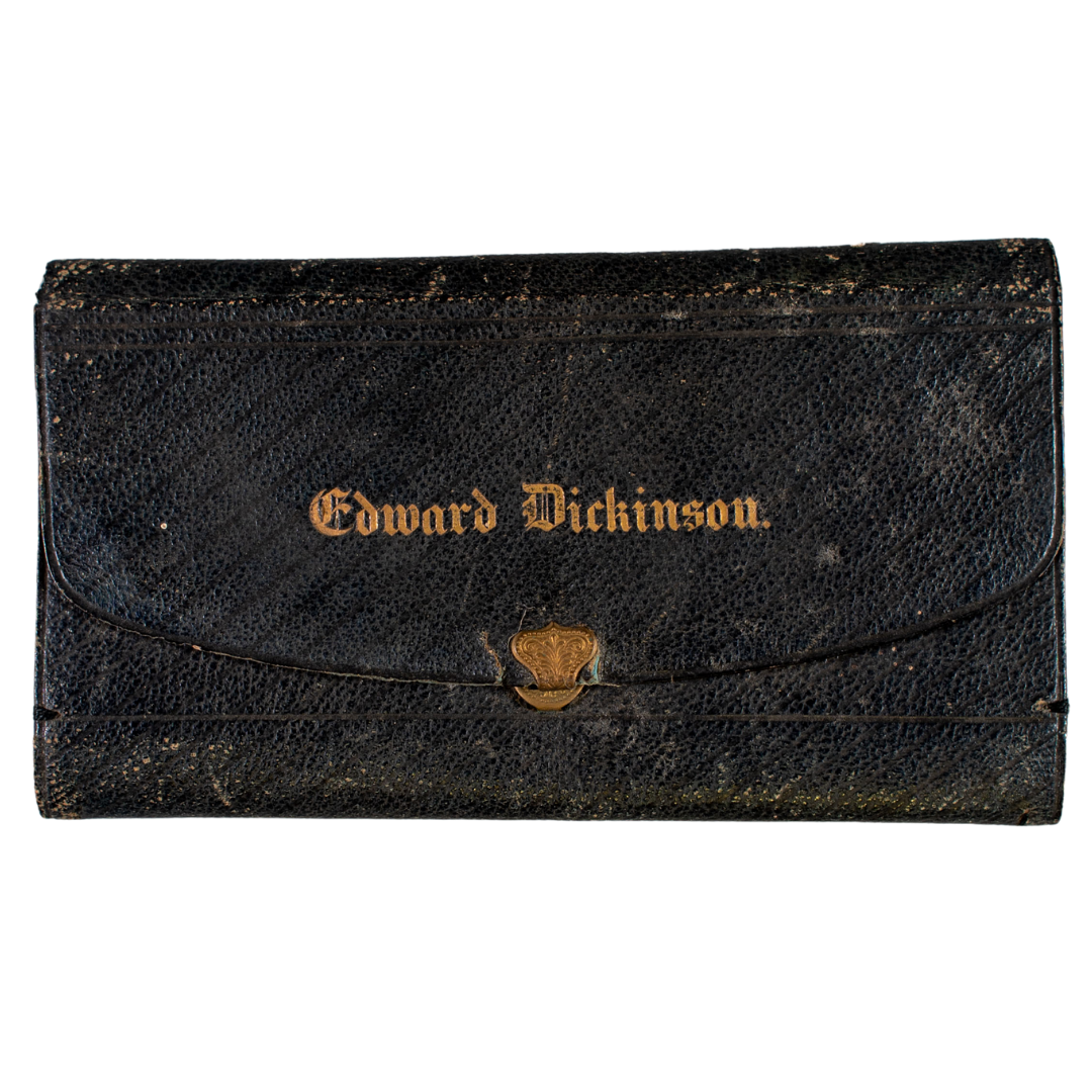 A black leather wallet with gold writing that says "Edward Dickinson"