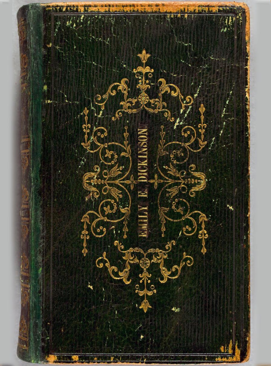 Front face of a book bound in green morocco leather, stamped with “Emily E. Dickinson” surrounded by a gilt floral motif.