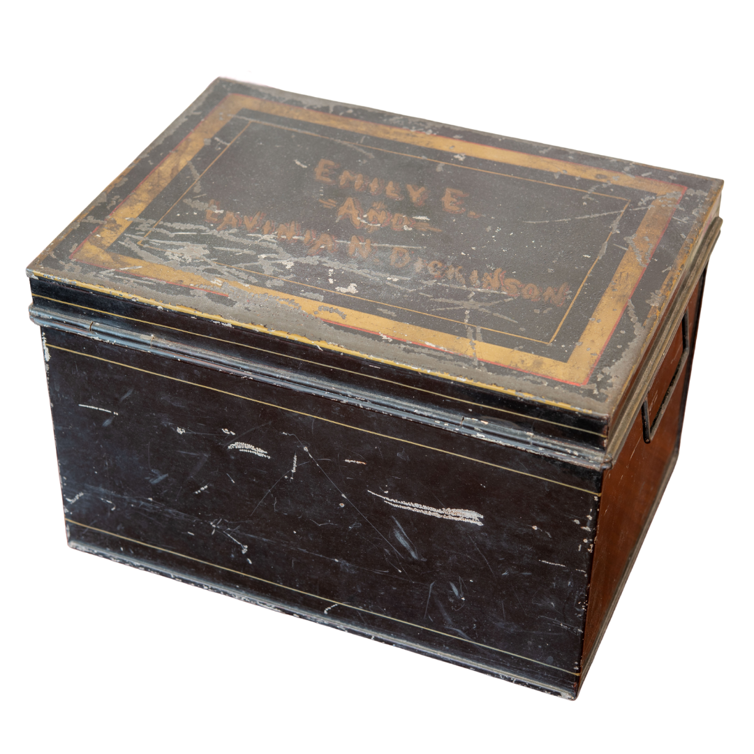 Metal box with many scratches and names imprinted on the top.