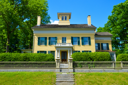 the exterior of Emily Dickinson's yellow house on a sunny day
