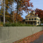 Emily Dickinson homestead, a yellow house, viewed from the sidewalk in autumn