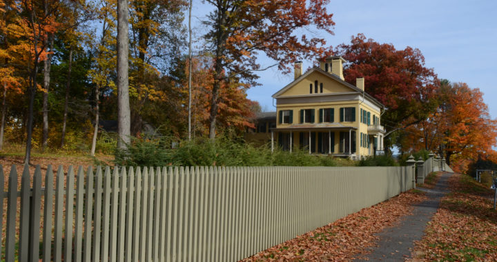 Emily Dickinson homestead, a yellow house, viewed from the sidewalk in autumn