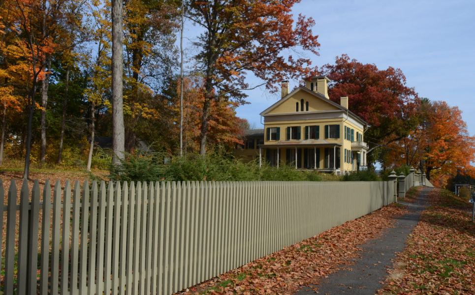 Emily Dickinson homestead, a yellow house, viewed from the sidewalk in autumn