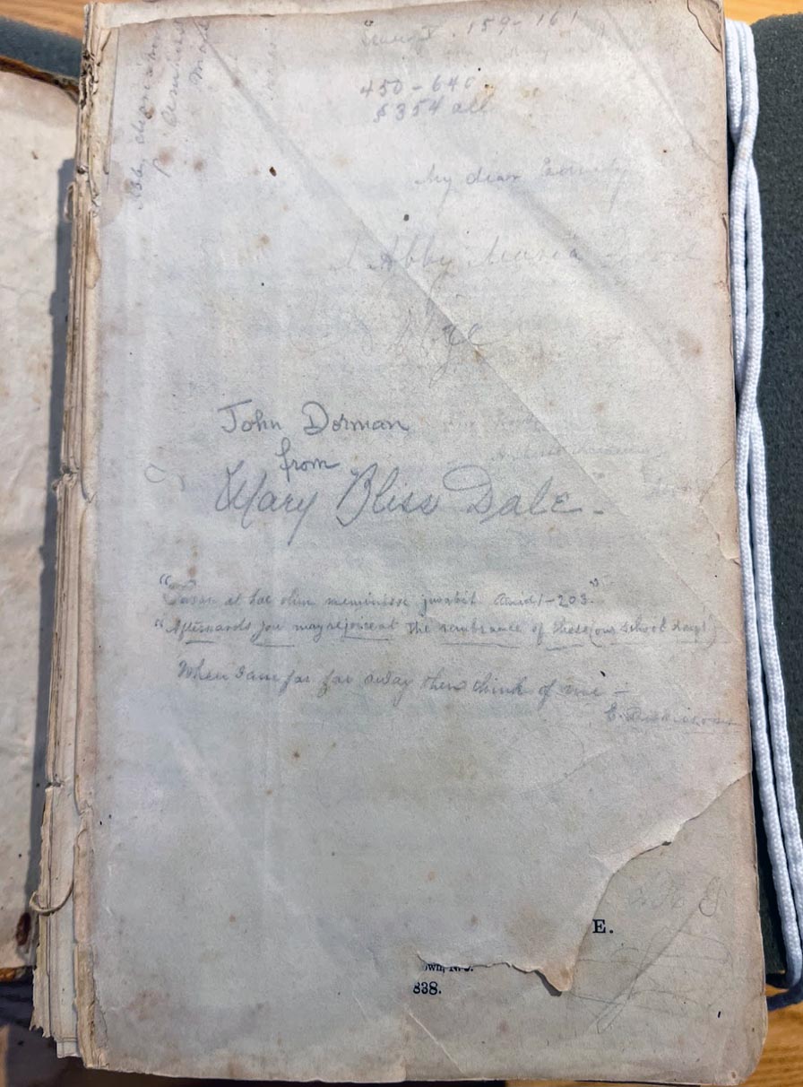 Three penciled lines on a well-worn page, written in a miniscule hand with many underscores. Signed “E. Dickinson.”