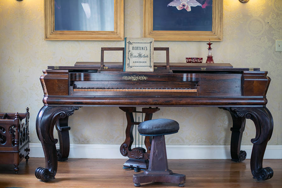 Square piano by Wilkinson & Co., Bertini Piano Method book in the stand. Black horsehair stool at the ready.