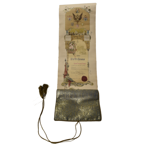 A long scroll that has been rolled out that contains Russian text. There is a tassel at the end of the paper.