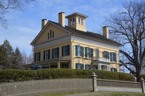 The exterior front of the Homestead with scaffolding up to the roof