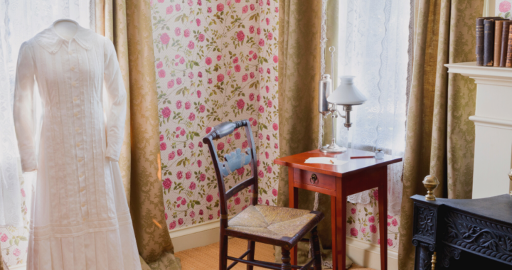 Image of Dickinson's room featuring her writing desk and white dress