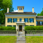 the exterior of Emily Dickinson's yellow house on a sunny day