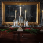 three candles sit on the mantle in The Evergreens