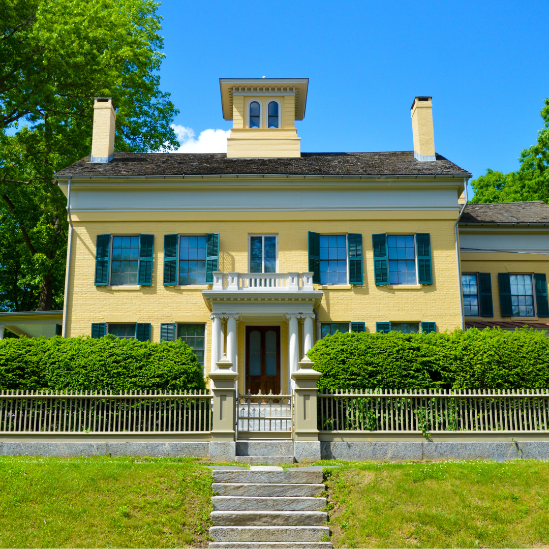 the exterior of Emily Dickinson's yellow house on a sunny day