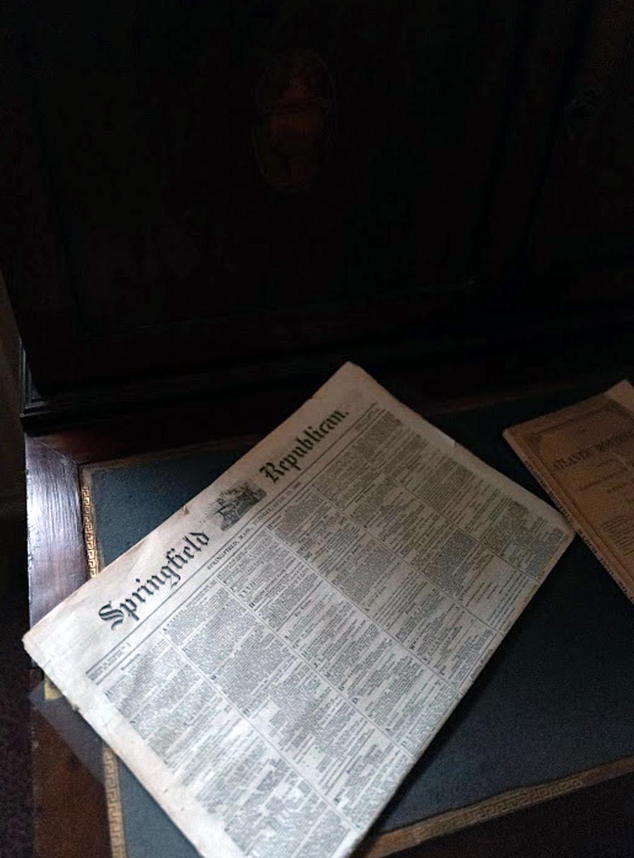 Historic Springfield Republican newspaper resting on a desk. The miniscule print is arranged in six columns.