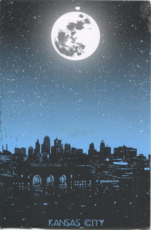 Colored postcard of moon over cityscape