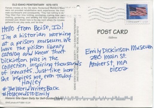 handwritten inscription on the back of a postcard in blue ink..