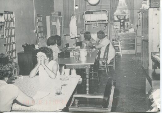 black and white photo of incarcerated women playing cards.