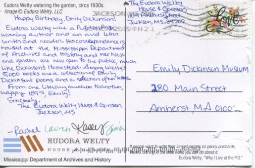 verso of postcard with handwritten inscription in blue ink