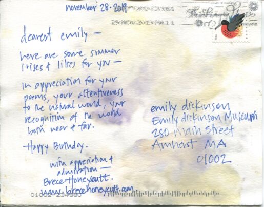 Handwritten message on the back of a postcard in blue ink.