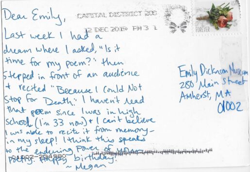 Postcard verso featuring a handwritten inscription in blue ink