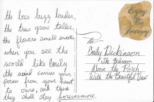 Postcard verso featuring a handwritten inscription in black ink and a sticker reading "Enjoy The Journey!"