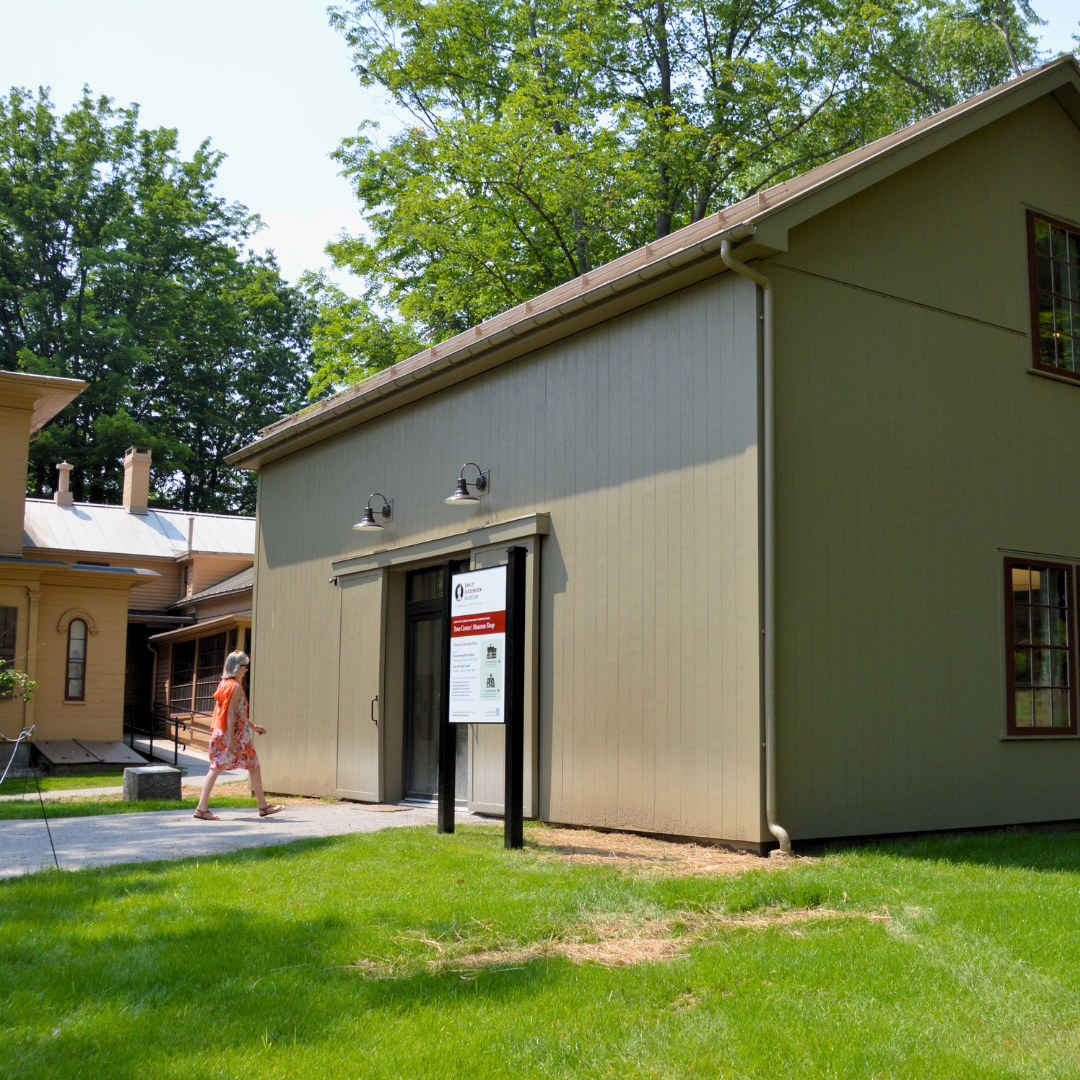 a woman walks into the newly reconstructed carriage house