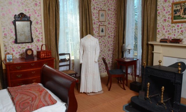 Emily Dickinson's white dress on a stand in her bedroom