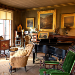 The Evergreens parlor filled with Dickinson family objects including furniture, paintings, instruments and more