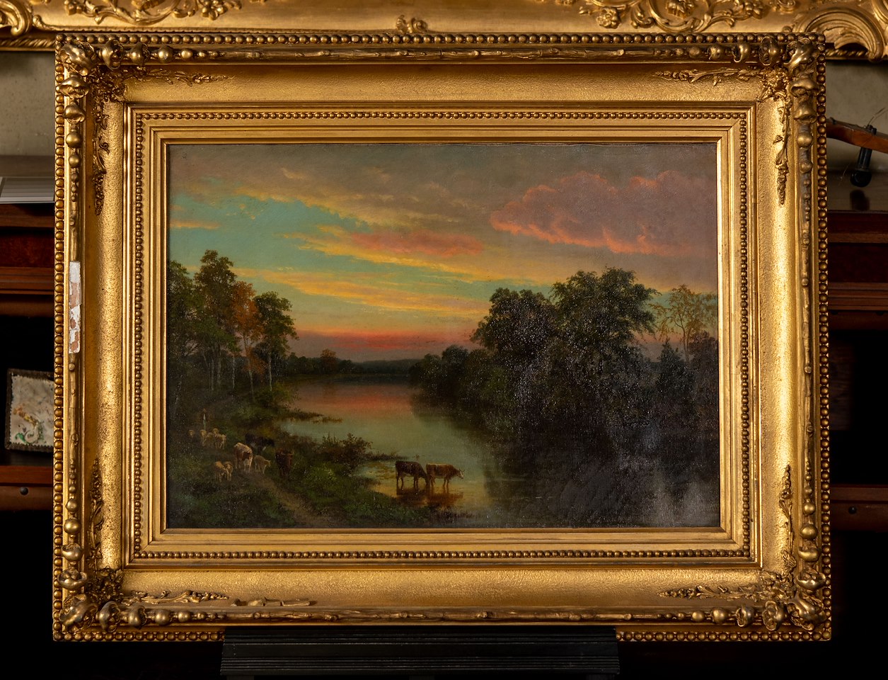Painting of sunset over river with figure driving a herd of cattle on a tree-lined path