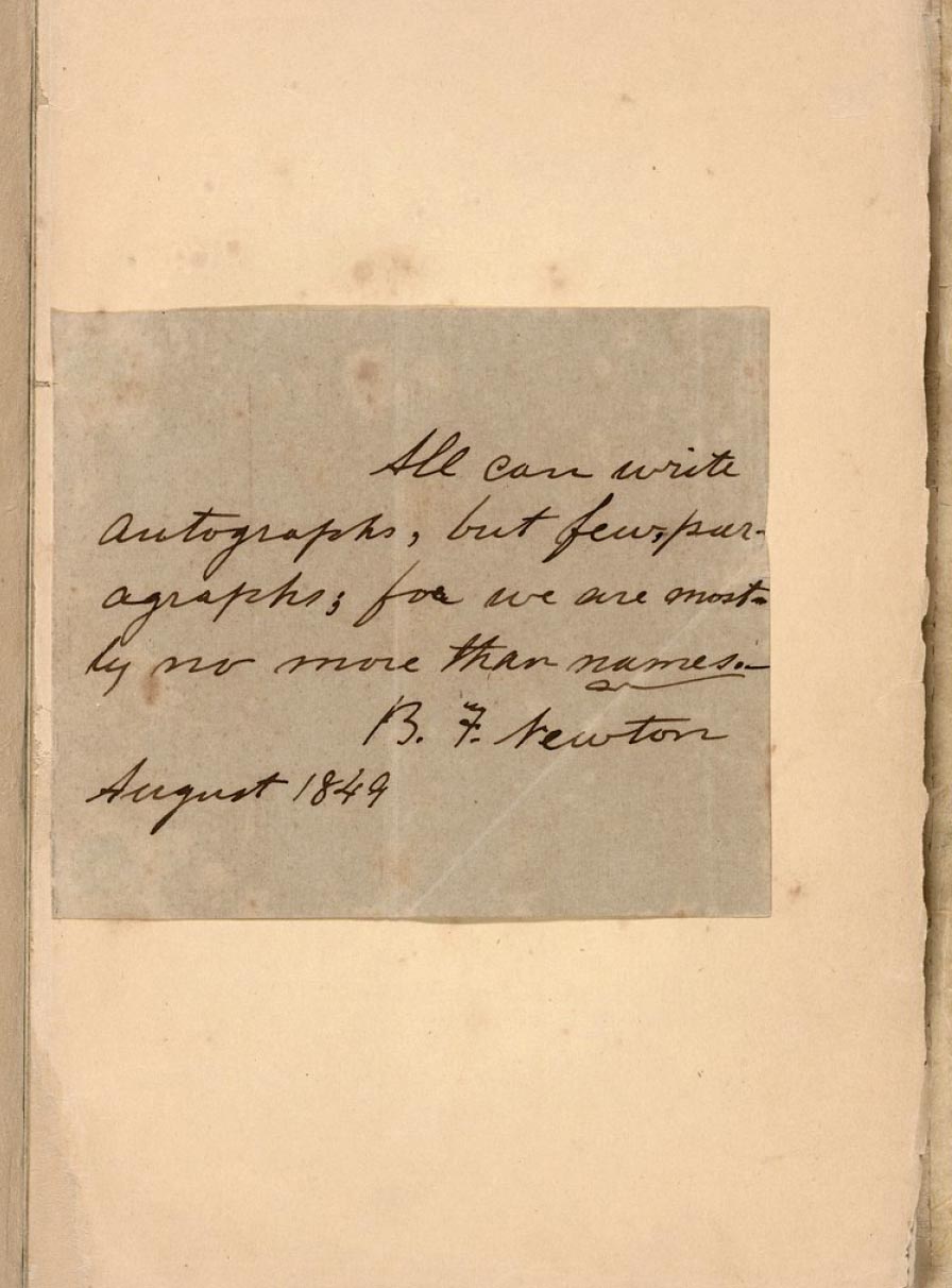Image of the right half of an open book. Pasted inside is an autographed square of browned paper with a dedication in ink.